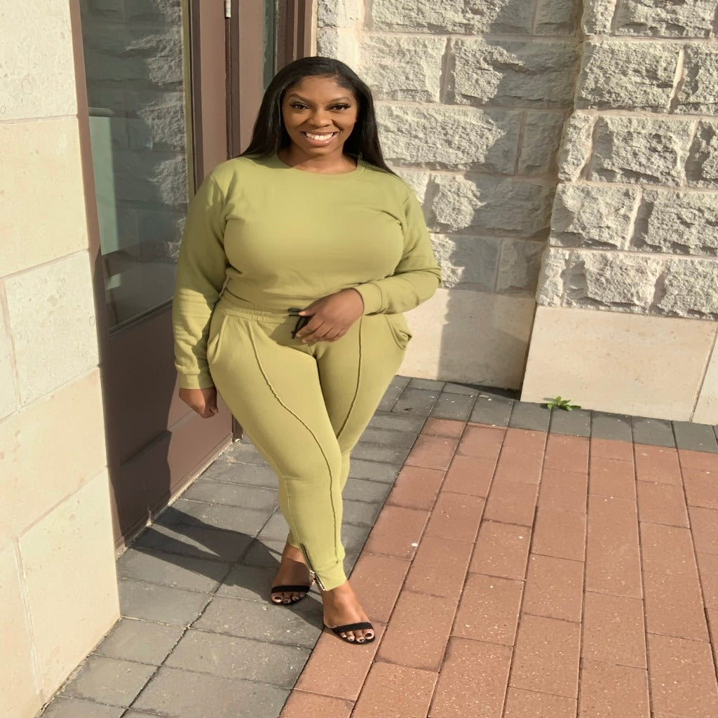 sweater and pants outfit in the color olive worn by curvy woman outside