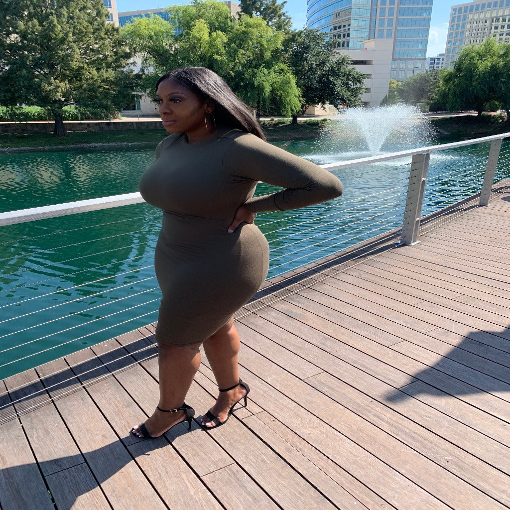 long sleeve bodycon dress in the color olive wearing outfit at lake